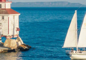 Journeyer our Downeaster 38 Ketch sailing in the bay near the Thunder Bay main lighthouse