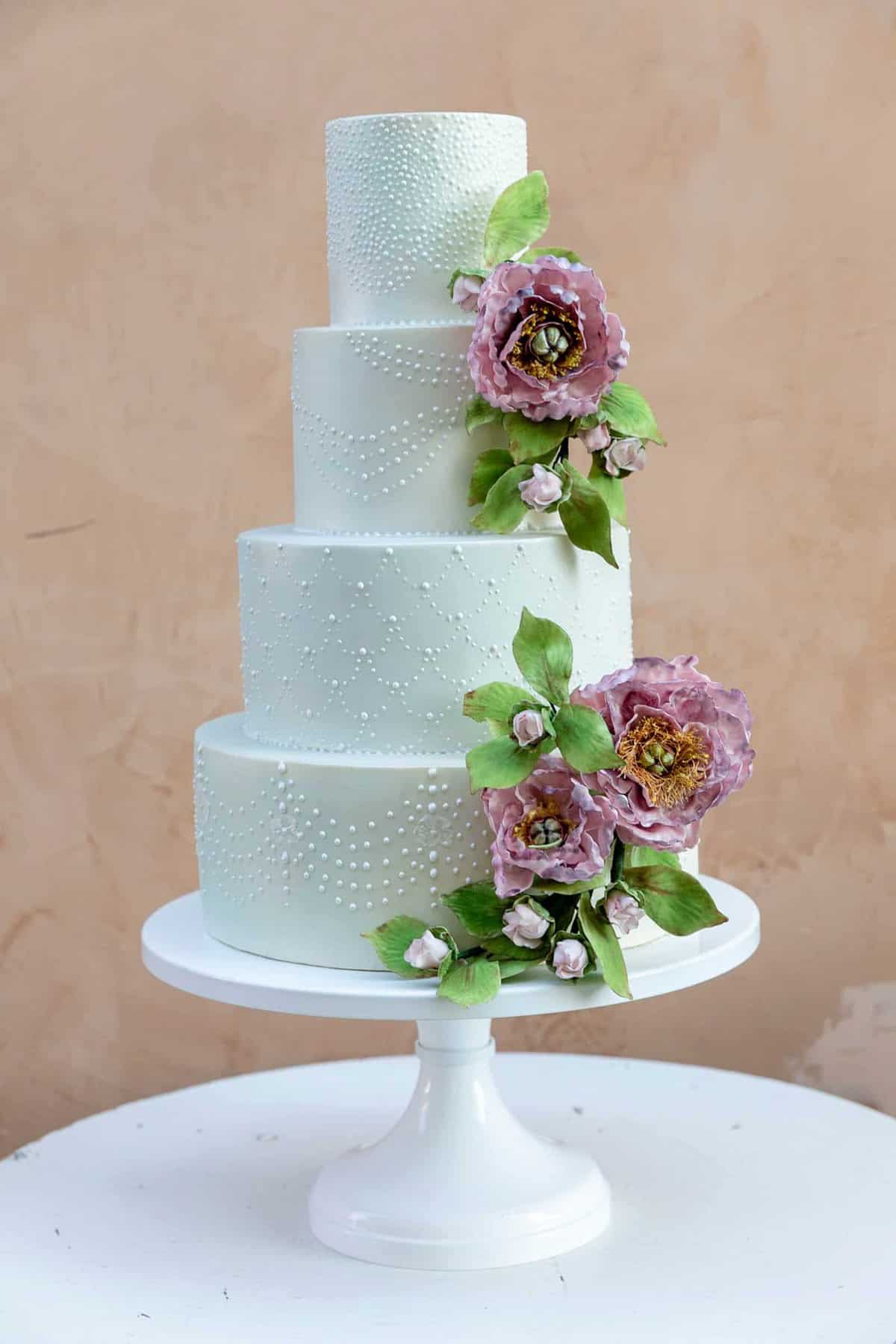 Modern tiered cake with classic piped pearls and sugar peonies by Tuscan Wedding Cakes