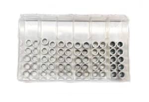 Organized small metal rings in clear storage container for manufacturing parts.