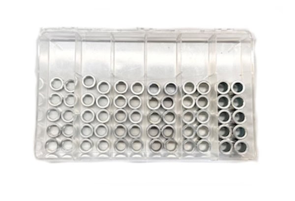Organized small metal rings in clear storage container for manufacturing parts.