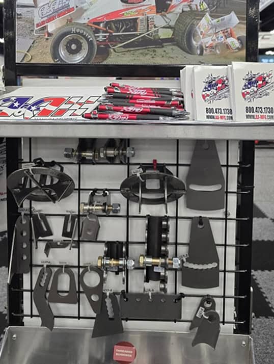 High-performance racing parts display with wheel hubs, pedals, and accessories for motorsport precision.