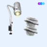 The Sunflower II LED Nail Dust Collector features a silver, flexible-arm LED light with a vented cylindrical head that emits a bright yellow beam. It attaches securely to surfaces with a sturdy metal clamp, shown against a pale blue background. There are also a pile of filters indicating the extra package that comes with the Sunflower II Extra Value Package. Read more at Aerovex Systems (aerovexsystems.com)