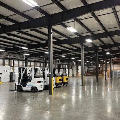 Empty warehouse with forklifts and high ceiling at AirportXchange.