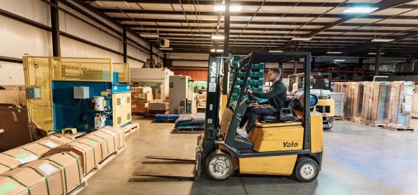 working picking up crates with forklift