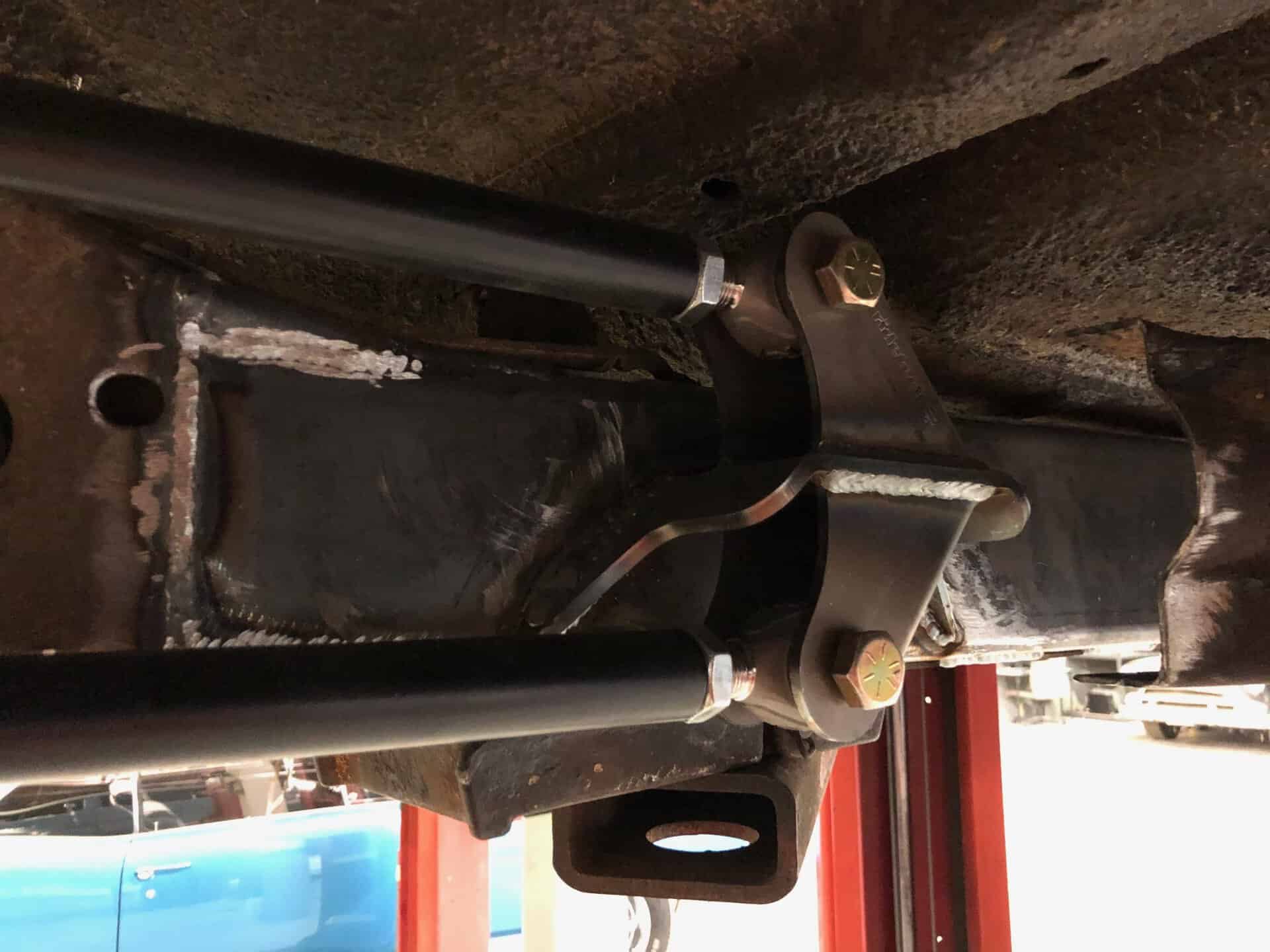 High-performance vehicle suspension component installation at All Speed Customs for enhanced car handling and stability.