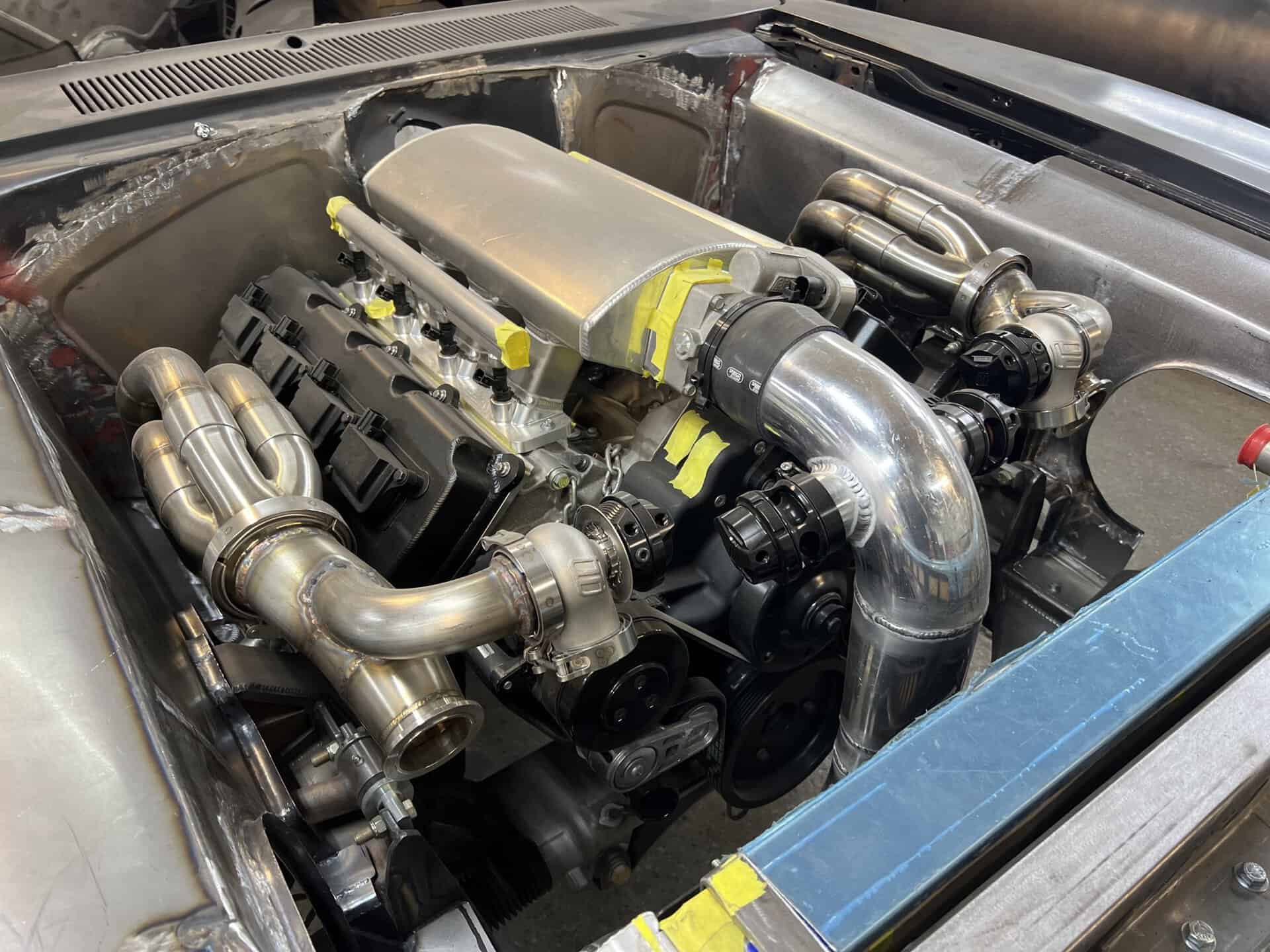 Detailed view of a custom high-performance engine with polished pipes and components.