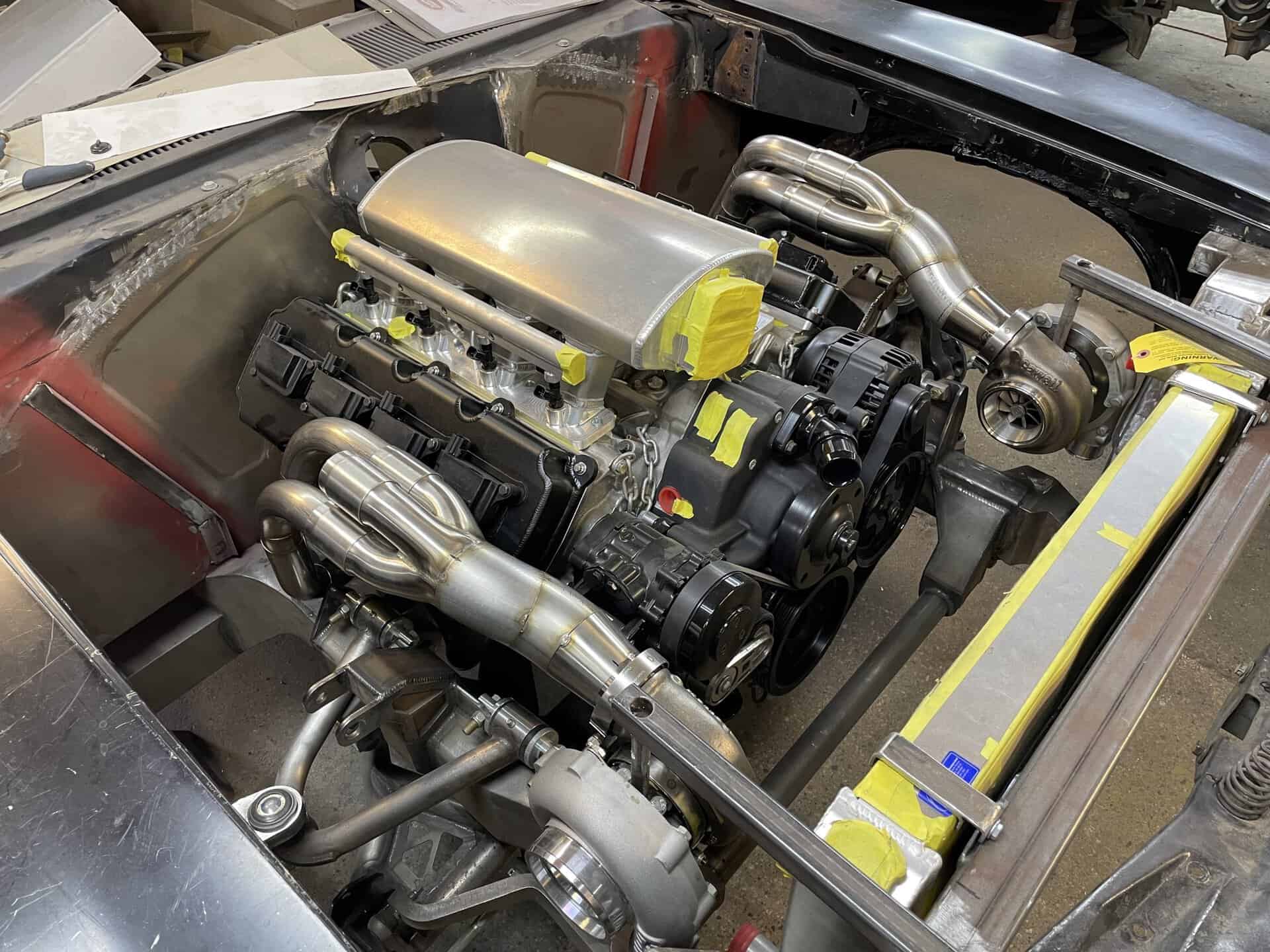High-performance engine with custom exhaust system in a classic car.