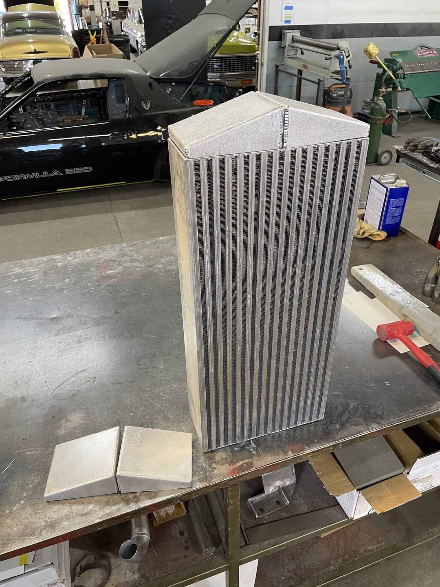 Aluminum radiator with vertical fins for Dodge Charger engine cooling.