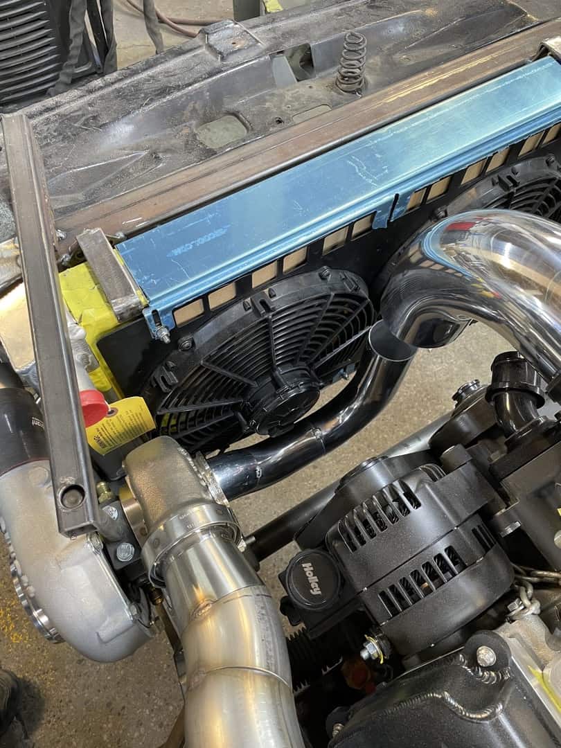 High-performance car engine with custom piping and cooling system.