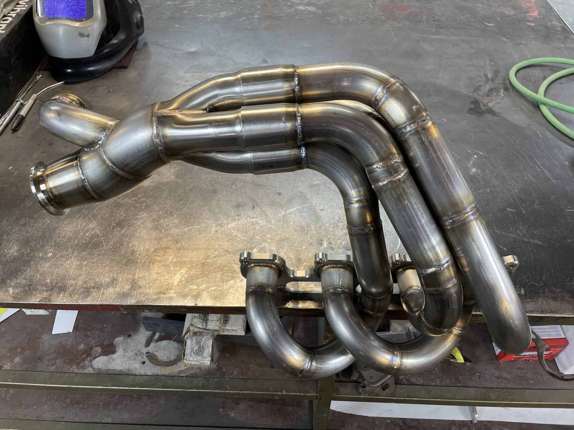 Metal exhaust pipes and headers for a 1968 Dodge Charger.