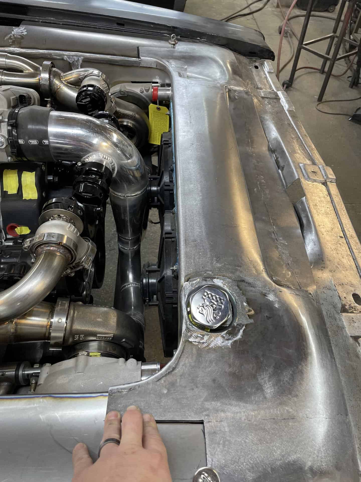 Engine bay with polished metal components and turbochargers.