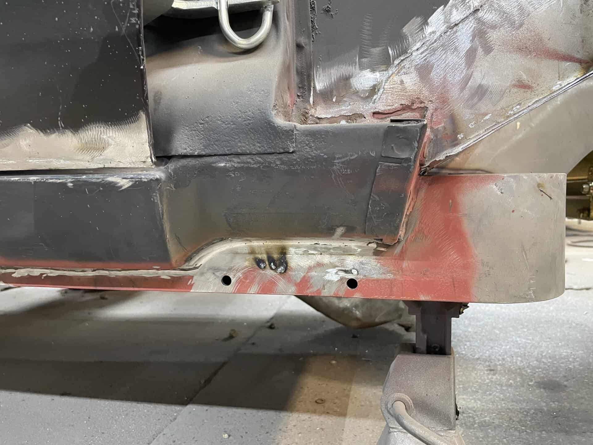 Close-up of car bodywork and welding in progress on a 1968 Dodge Charger.