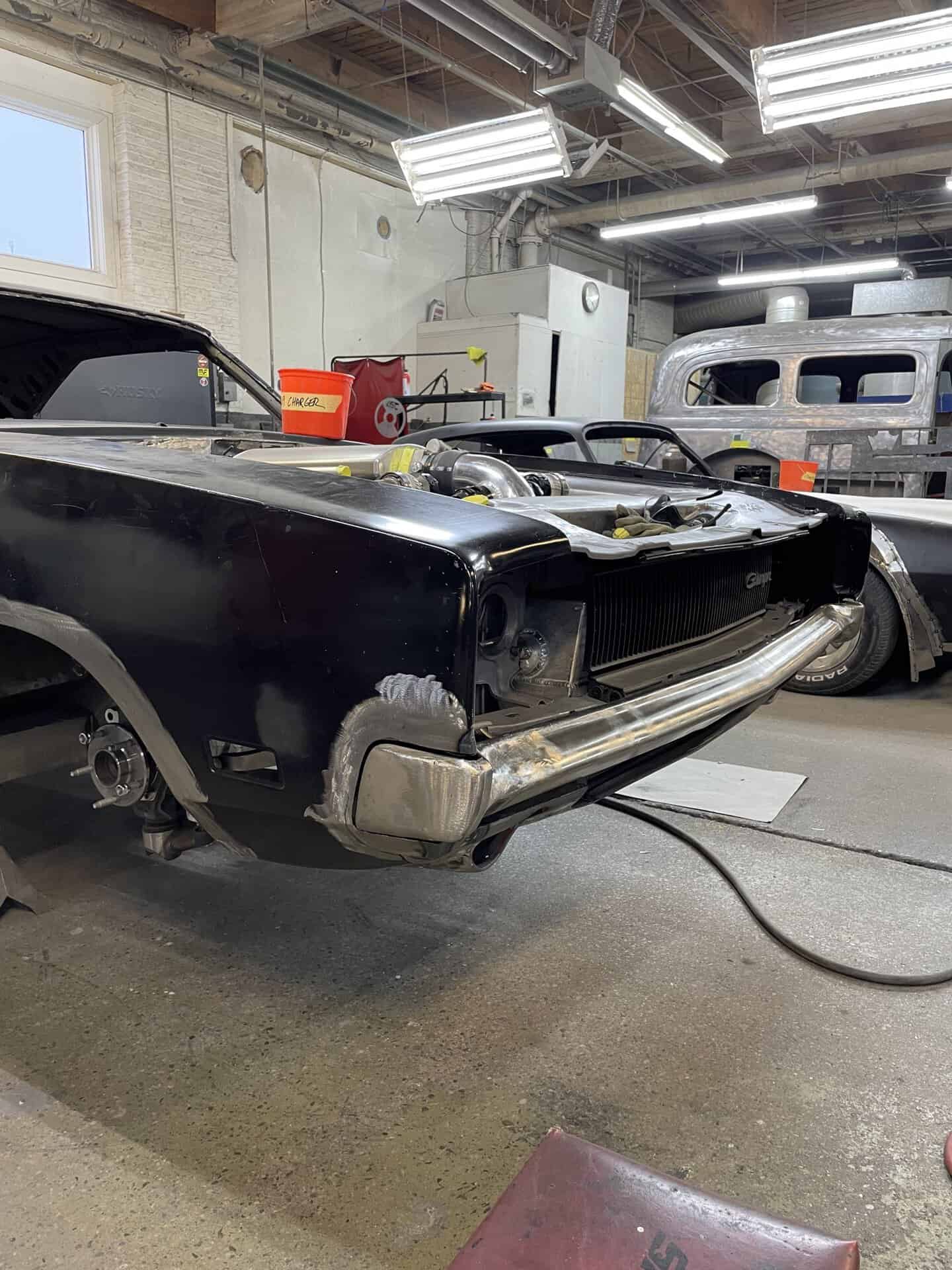Black 1968 Dodge Charger being restored at All Speed Customs workshop.