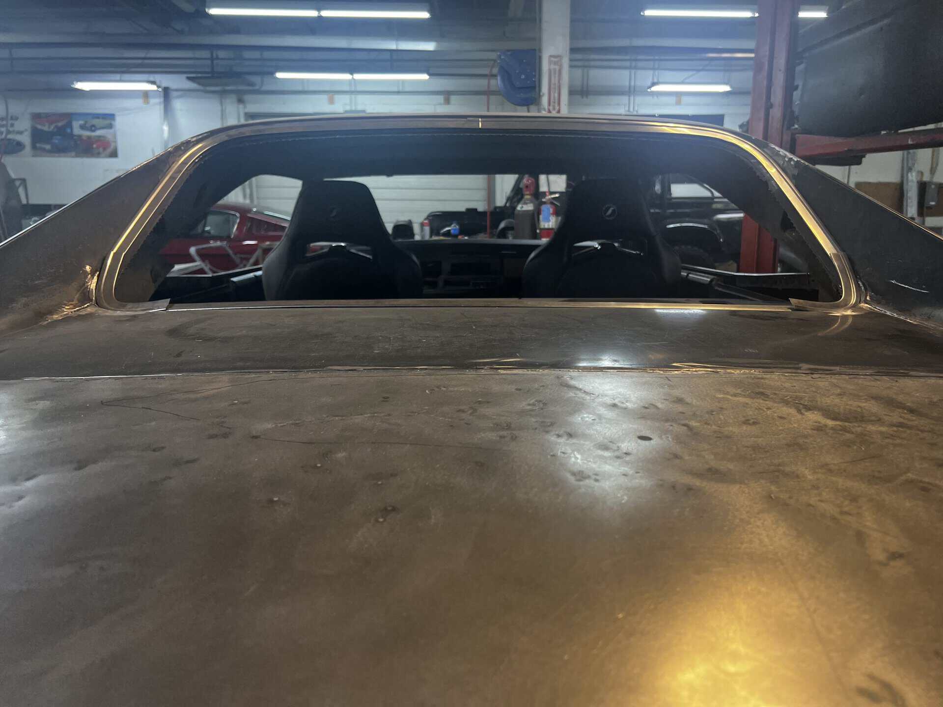 Interior view of a classic 1968 Dodge Charger in a workshop setting.
