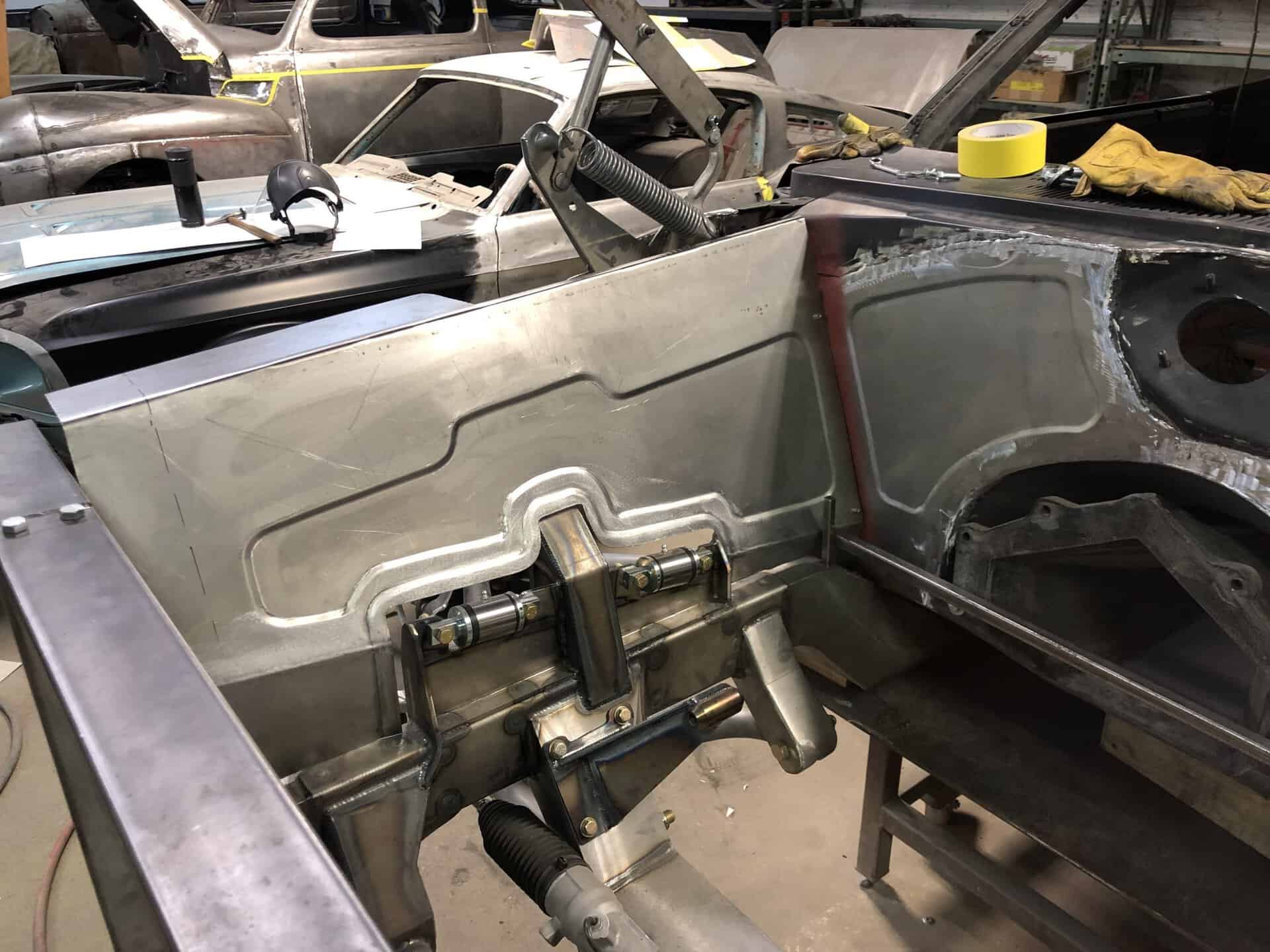 Restoring a 1968 Dodge Charger with metalwork and frame assembly.