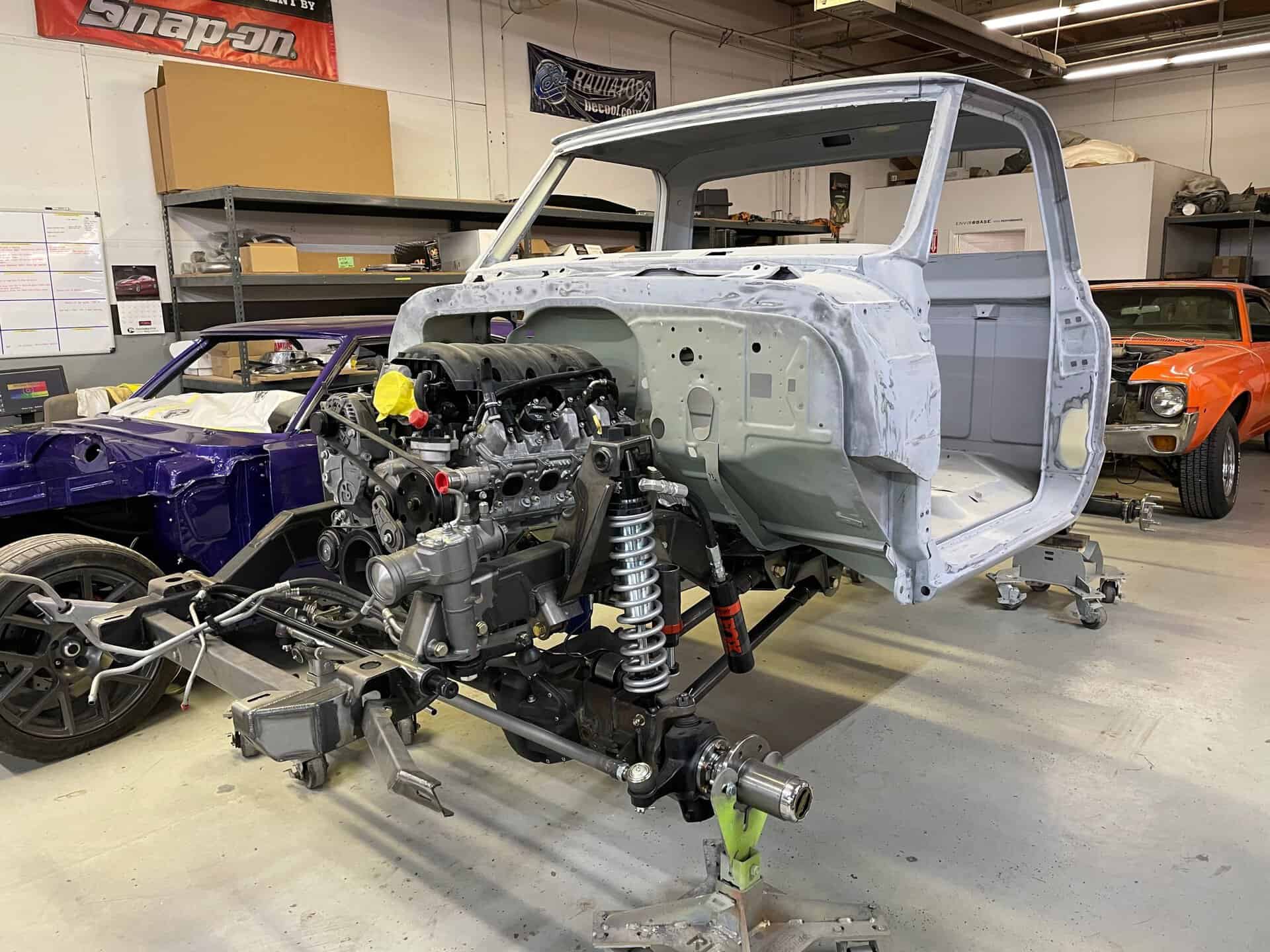 Partial view of a vintage Chevrolet K20 truck being restored in a workshop.