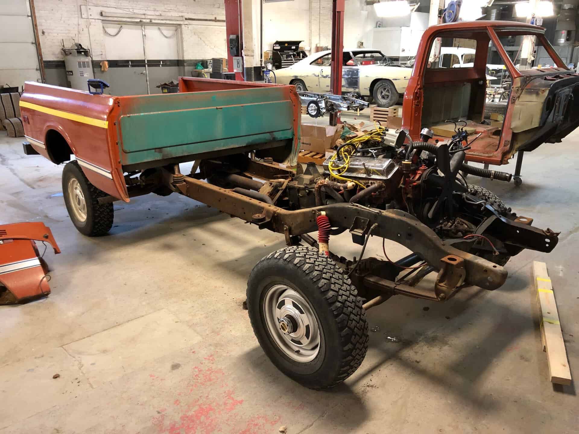 Partially disassembled 1969 Chevrolet K20 pickup truck in a workshop.