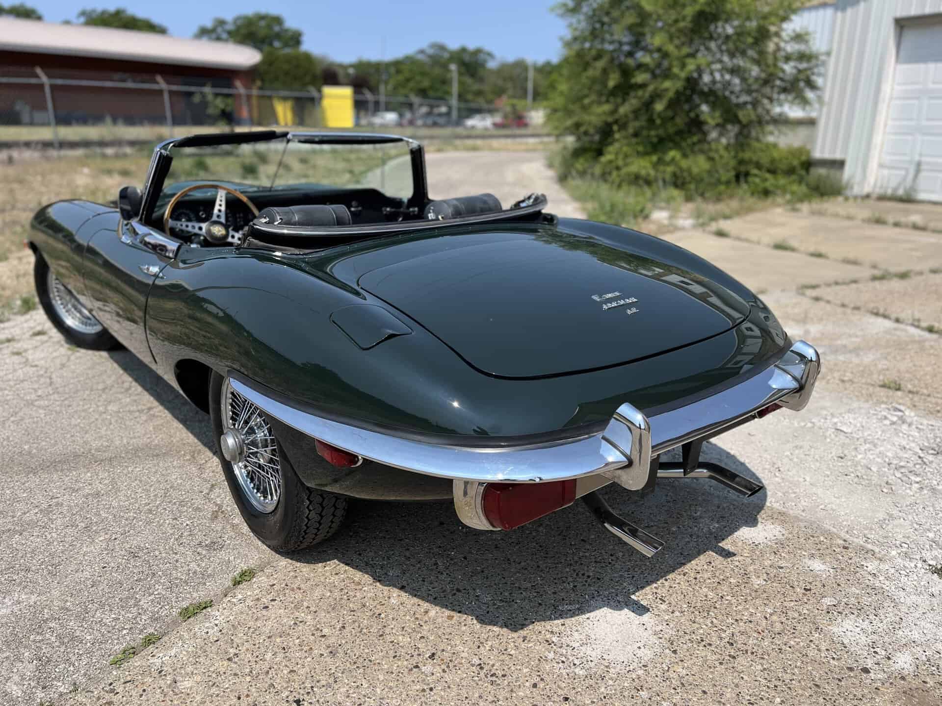 Classic 1970 Jaguar E-Type convertible with sleek dark green finish.