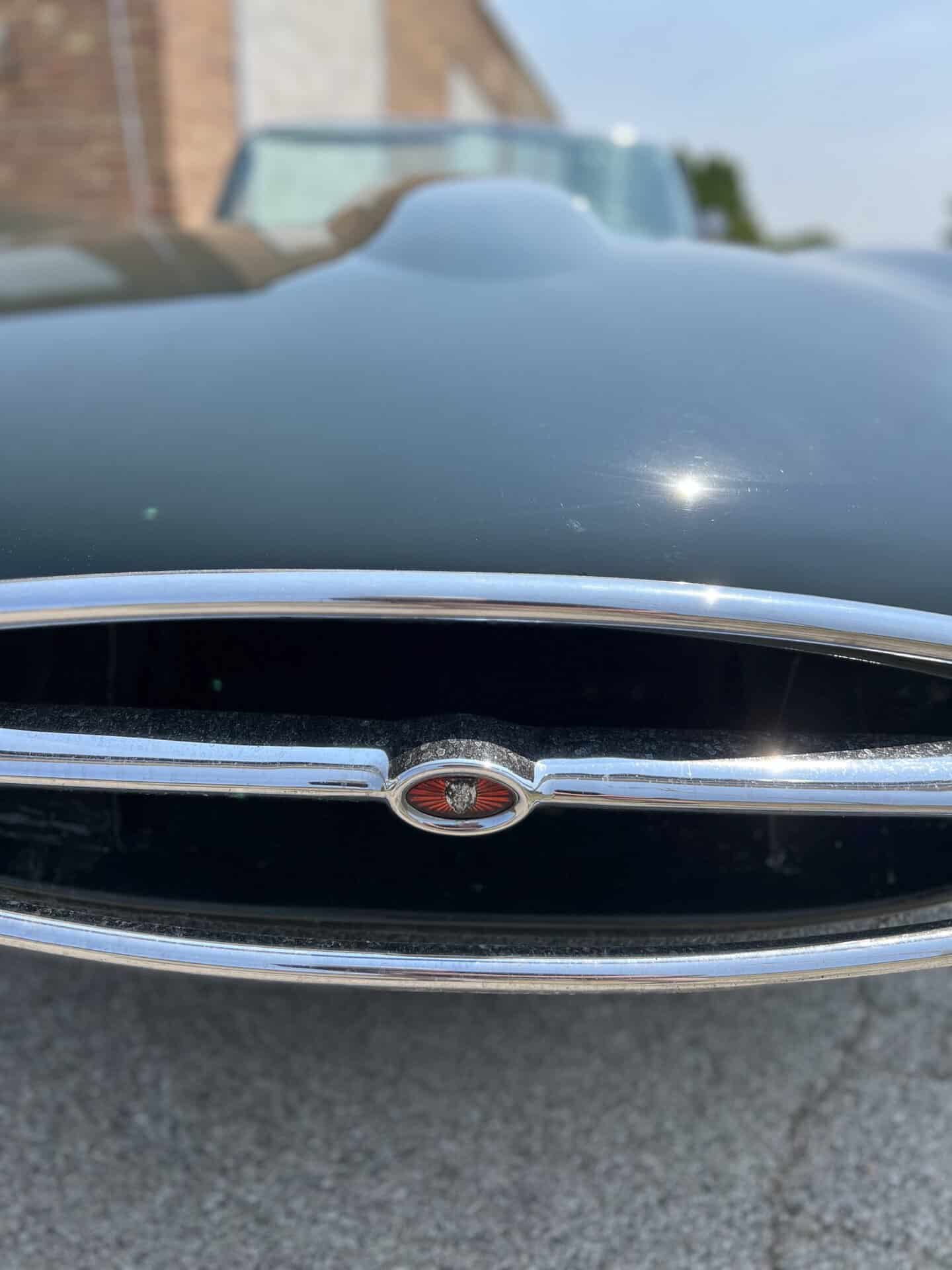 Close-up of the front grille and hood of a 1970 Jaguar E-Type.