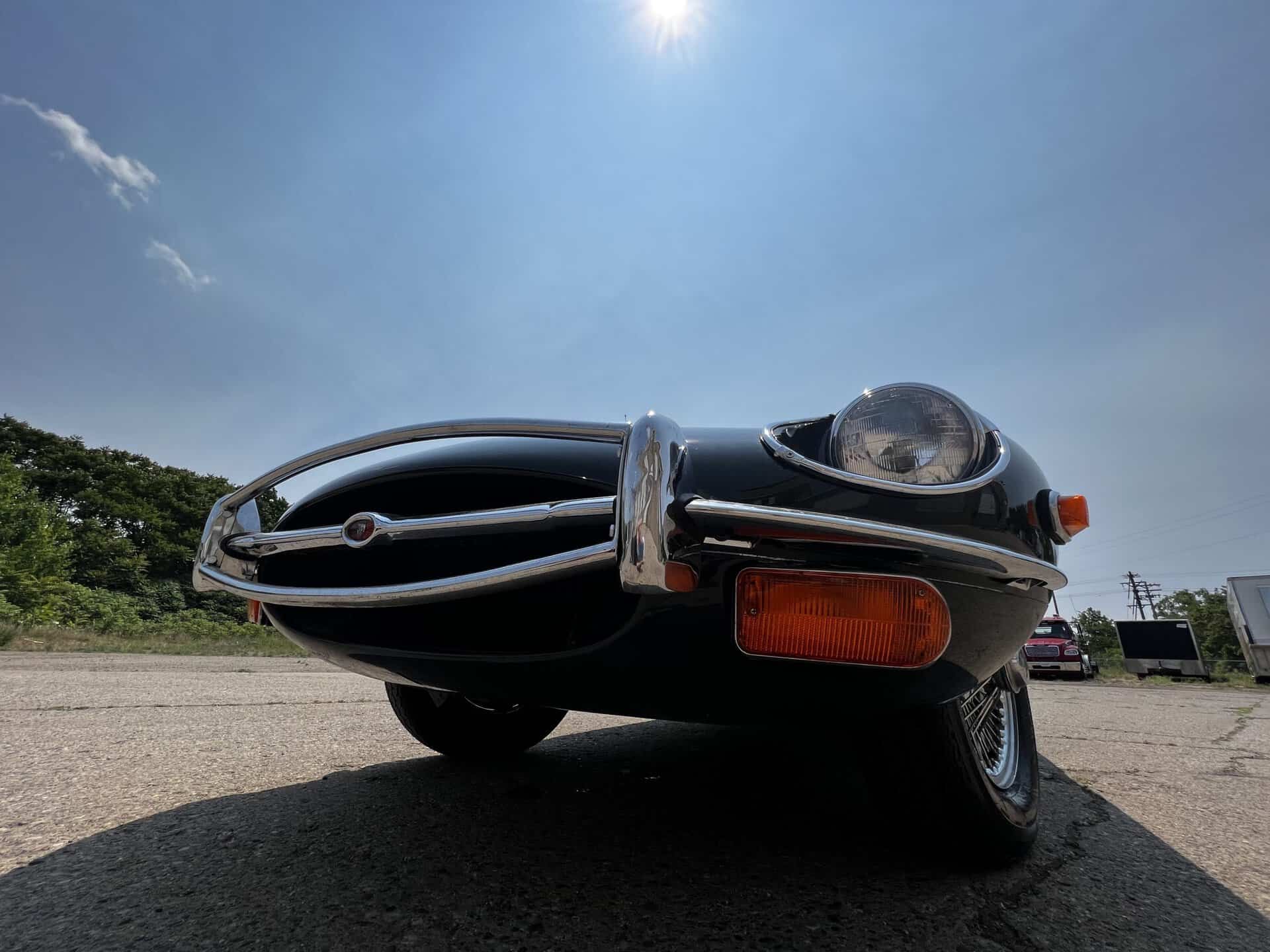 Vintage 1970 Jaguar E-Type sports car in black with chrome details.