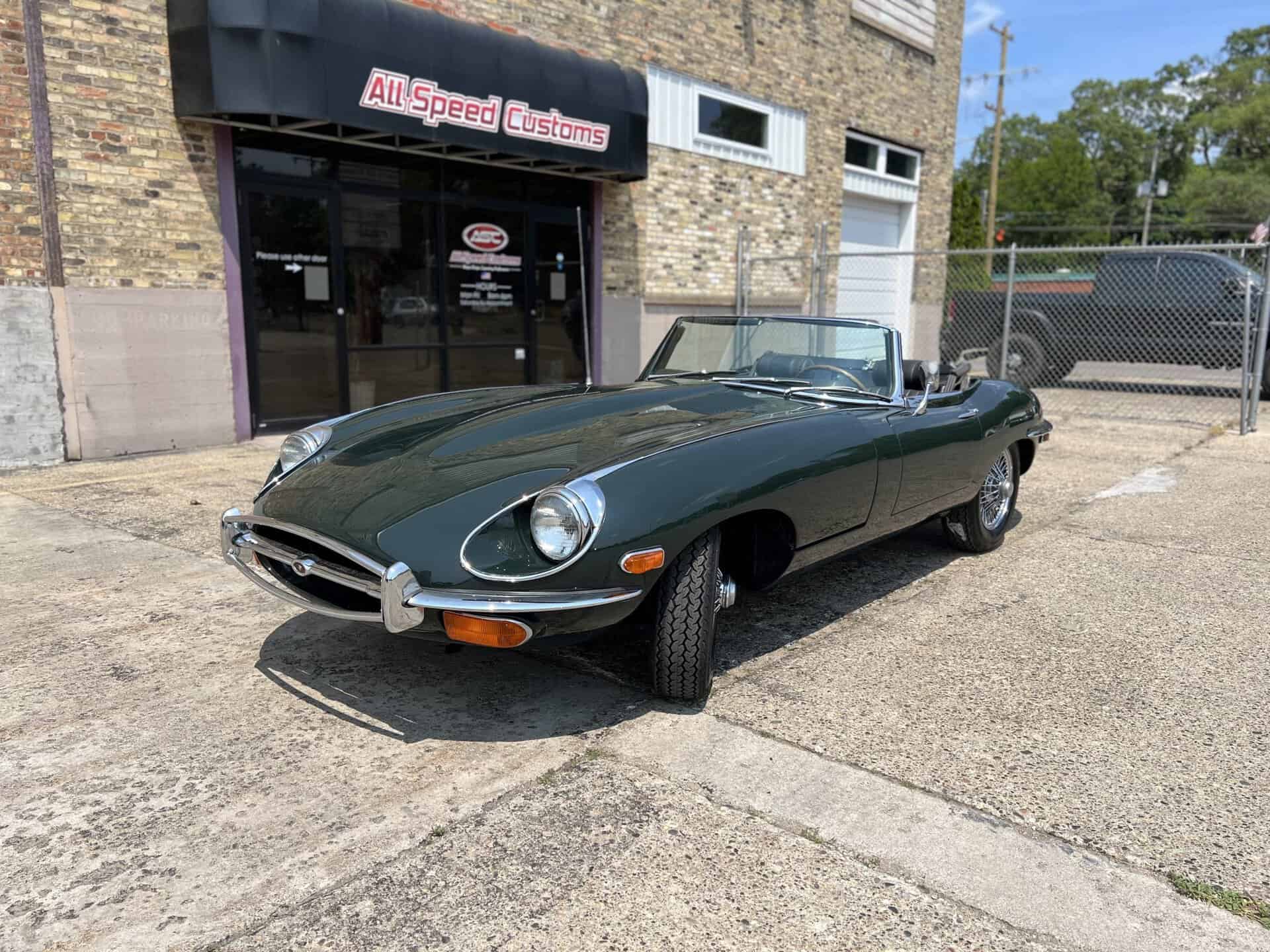 1970 Jaguar E-Type convertible parked outside All Speed Customs.