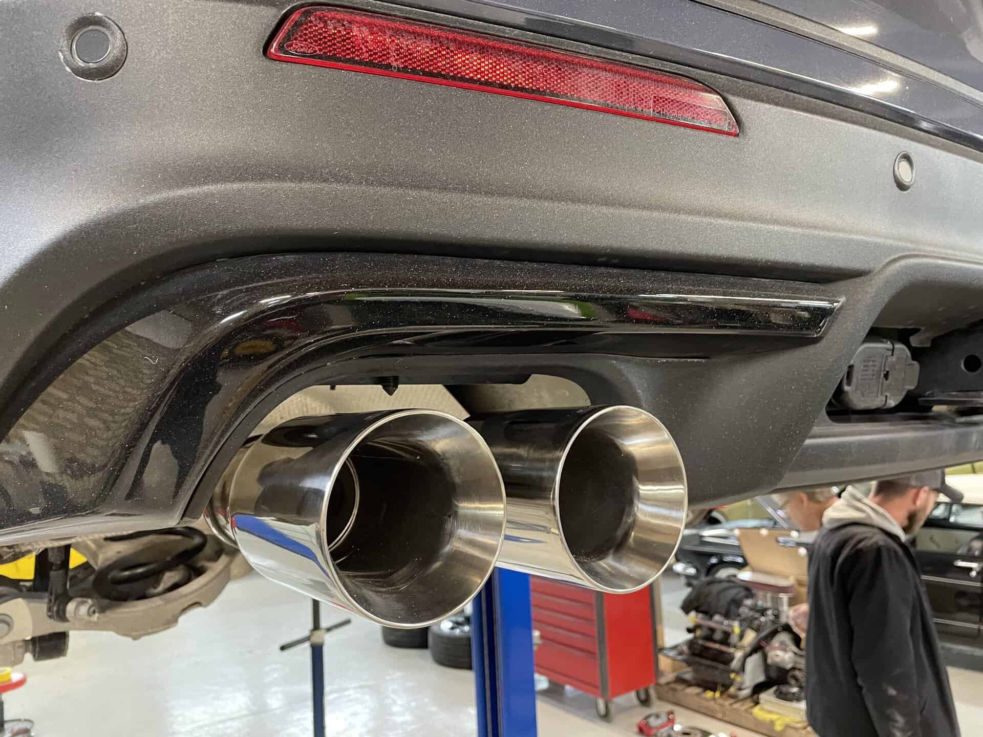 Close-up of dual chrome exhaust pipes on a Ford Explorer Sport.