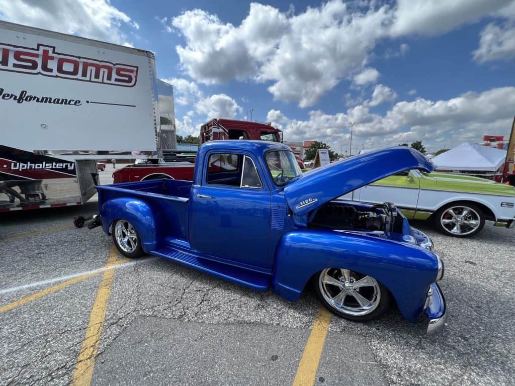 Blue vintage pickup truck with open hood at 2022 28th St. Metro Cruise.