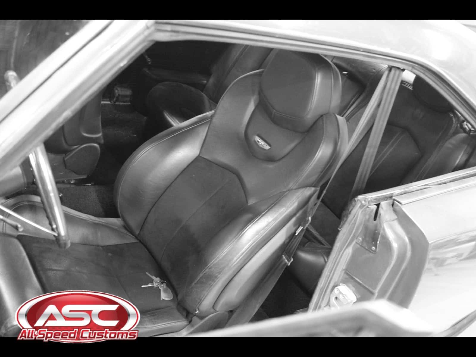Close-up of black leather car seat inside a 1968 Dodge Charger.