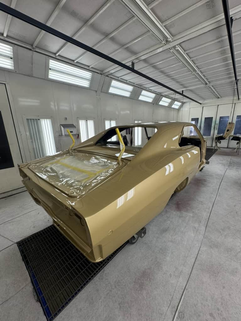 Restoring a vintage car body in a professional auto shop.