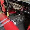 Custom classic car interior with performance upgrades, racing seats, and vintage dashboard.