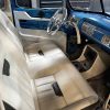 Classic car interior with custom upholstery and vintage dashboard design, showcasing expert automotive restoration.