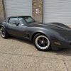 Classic Chevrolet Corvette sports car with custom modifications and sleek black finish.