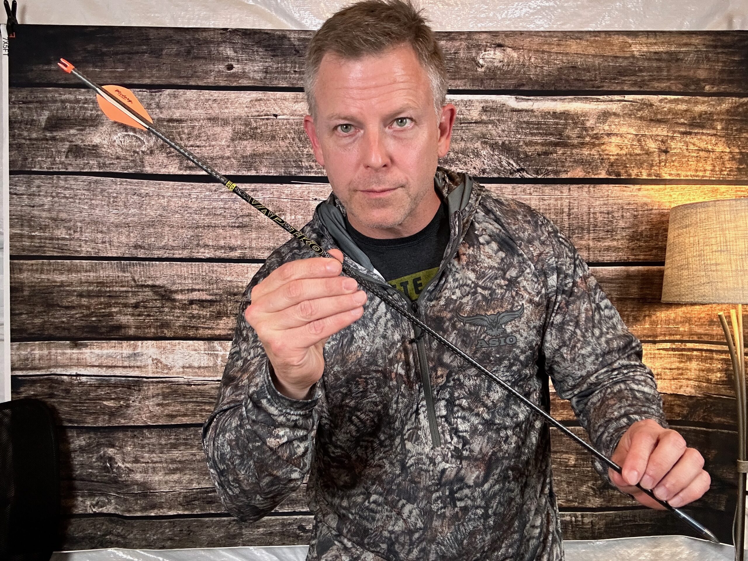 Mike Manley holding a hunting arrow while explaining arrow weight
