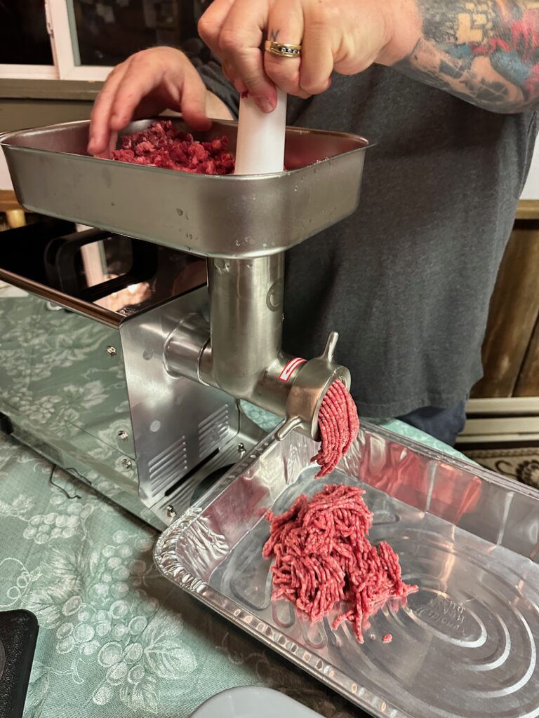 Starting the meat grinding process.