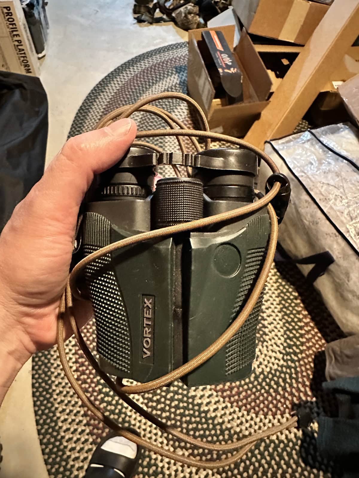 Vortex Vanquish 10x26 binoculars wrapped with the Rick Young Outdoors harness