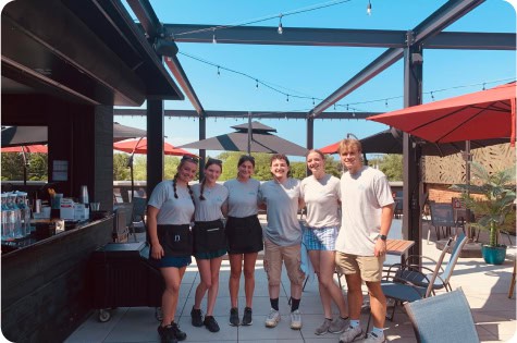 Group of friends enjoying rooftop dining at Attwood's Kitchen & Drink.