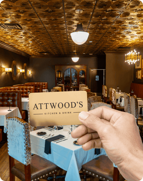 Attwood's Kitchen & Drink interior with elegant dining setup and vintage decor.
