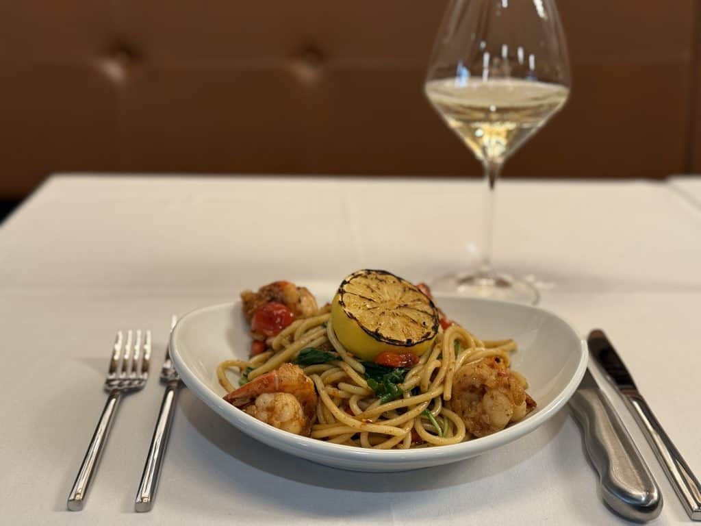 Delicious seafood pasta with grilled lemon and wine.