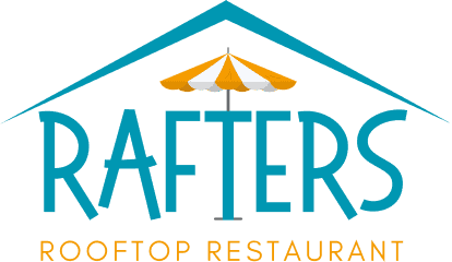 Rooftop dining area with stylish seating and scenic views at Attwood's Kitchen & Drink.