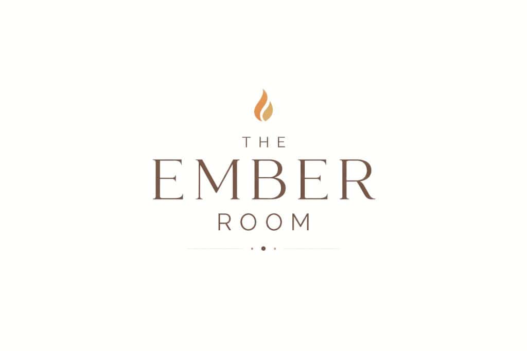 Warm ambiance with a crackling fireplace and elegant decor at The Ember Room