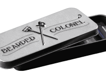 Bearded Colonel engraved storage tin, open, holding a razor and spare blades