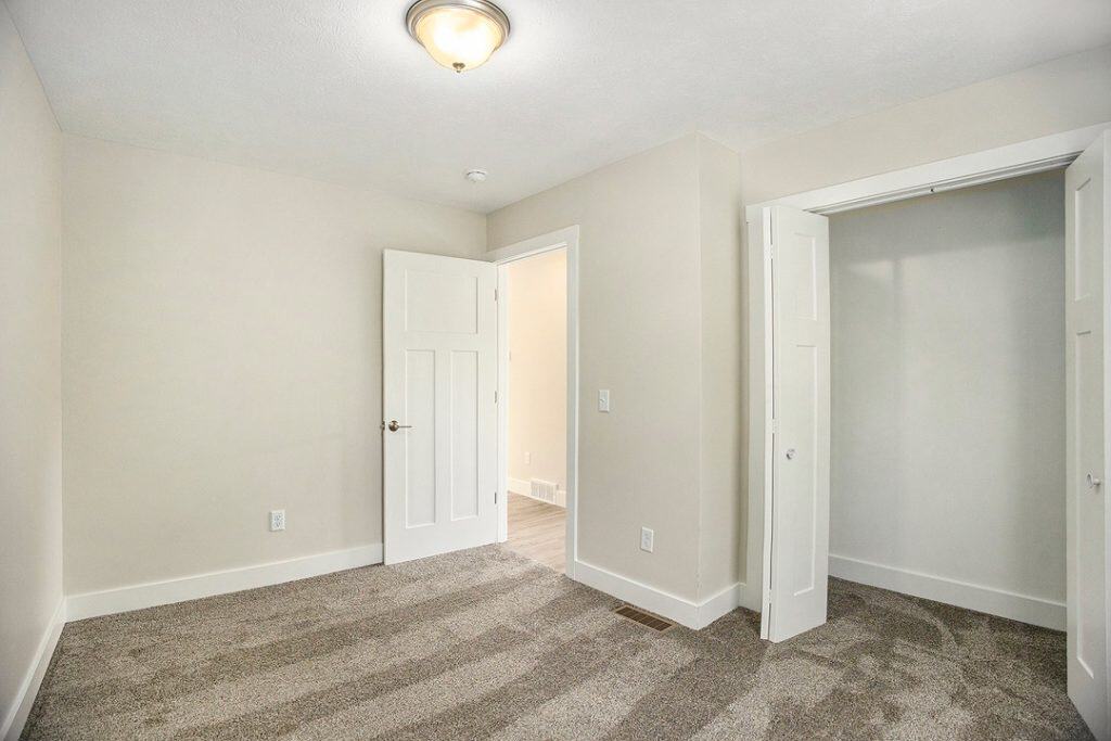 Empty bedroom with closet and neutral wall colors for home living.