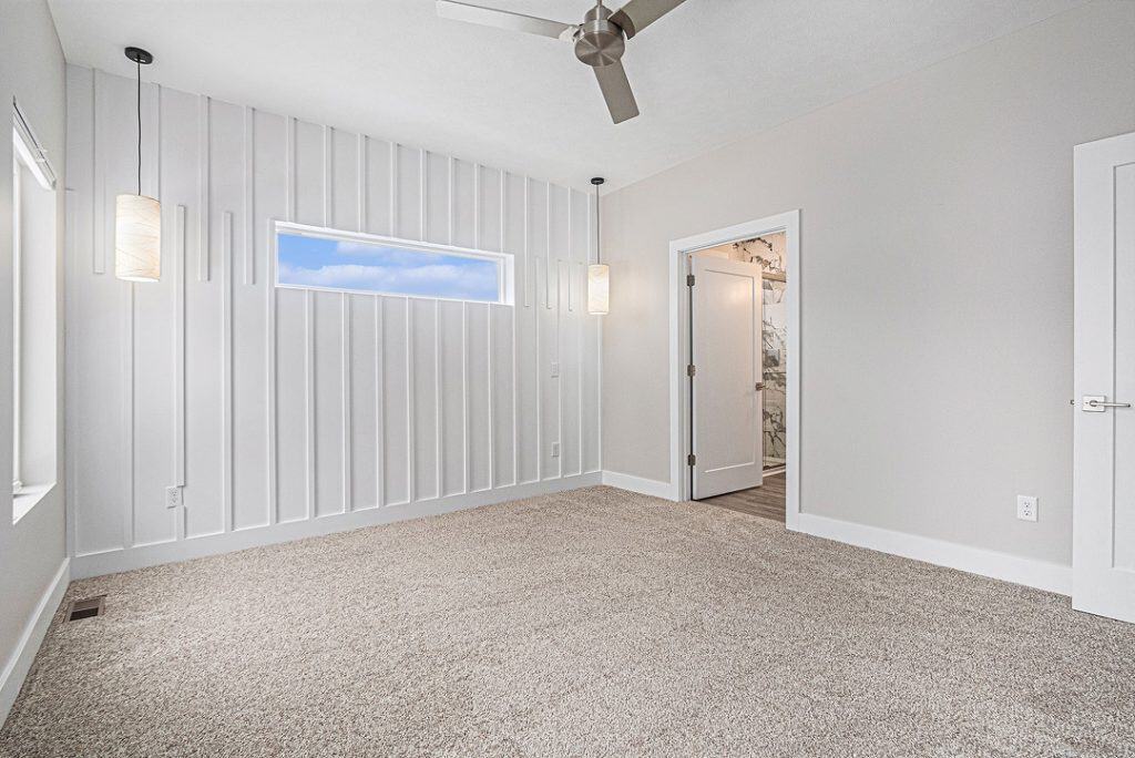 Bright, modern interior room with white walls and beige carpet.