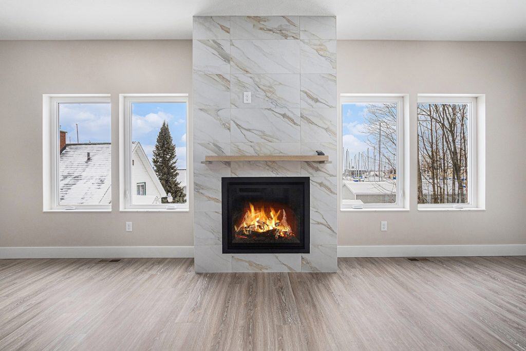 Contemporary living room with a fireplace and large windows.