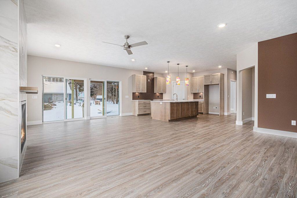 Spacious open-concept kitchen and living area with large windows and modern finishes.