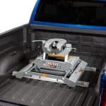 Patriot snow plow attachment in truck bed for sports equipment transport.