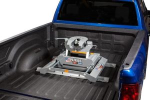 Patriot snow plow attachment in truck bed for sports equipment transport.