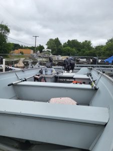 Used Sea Nymph 16 HD Camp boat with outboard motor and fishing gear.