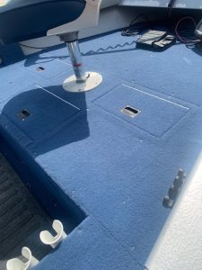 Boat deck with storage compartments and mounting hardware.