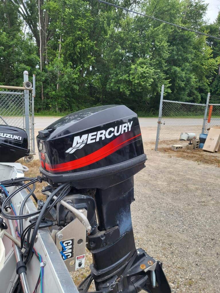 Mercury outboard motor attached to Sylvan 14 utility boat for sale.